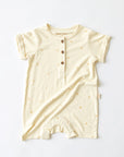 cream baby jumpsuit onesie with palm tree print and button up front